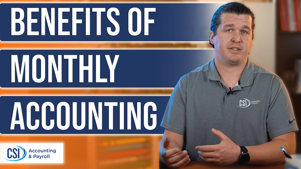 accountant at desk with text on screen