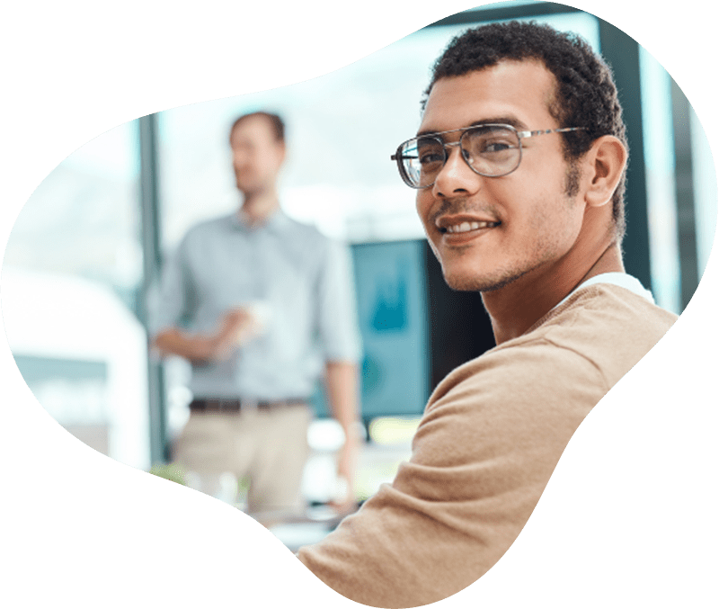 Smiling man looking over shoulder