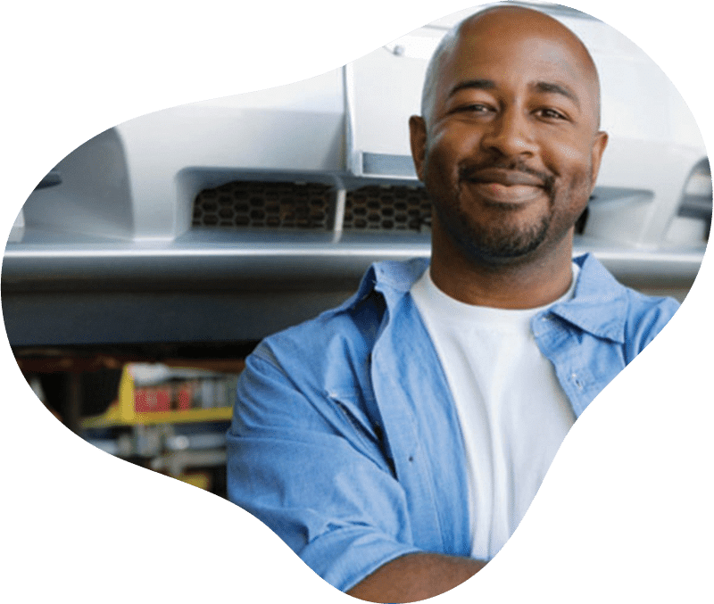 smiling man standing with arms crossed